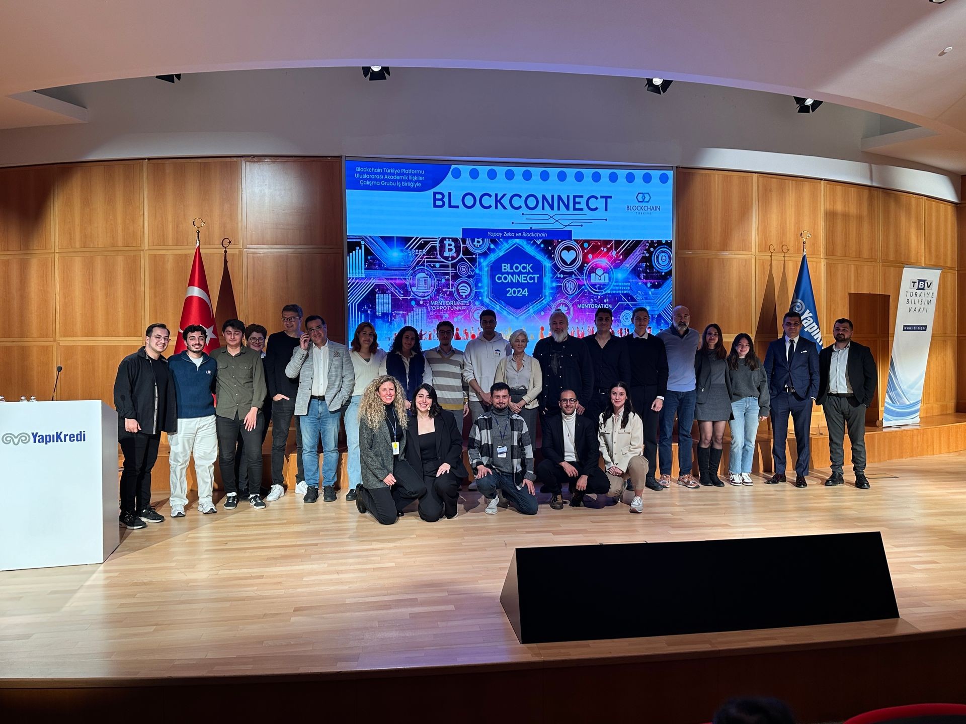 Group of people standing on a stage with a BlockConnect event banner in the background.