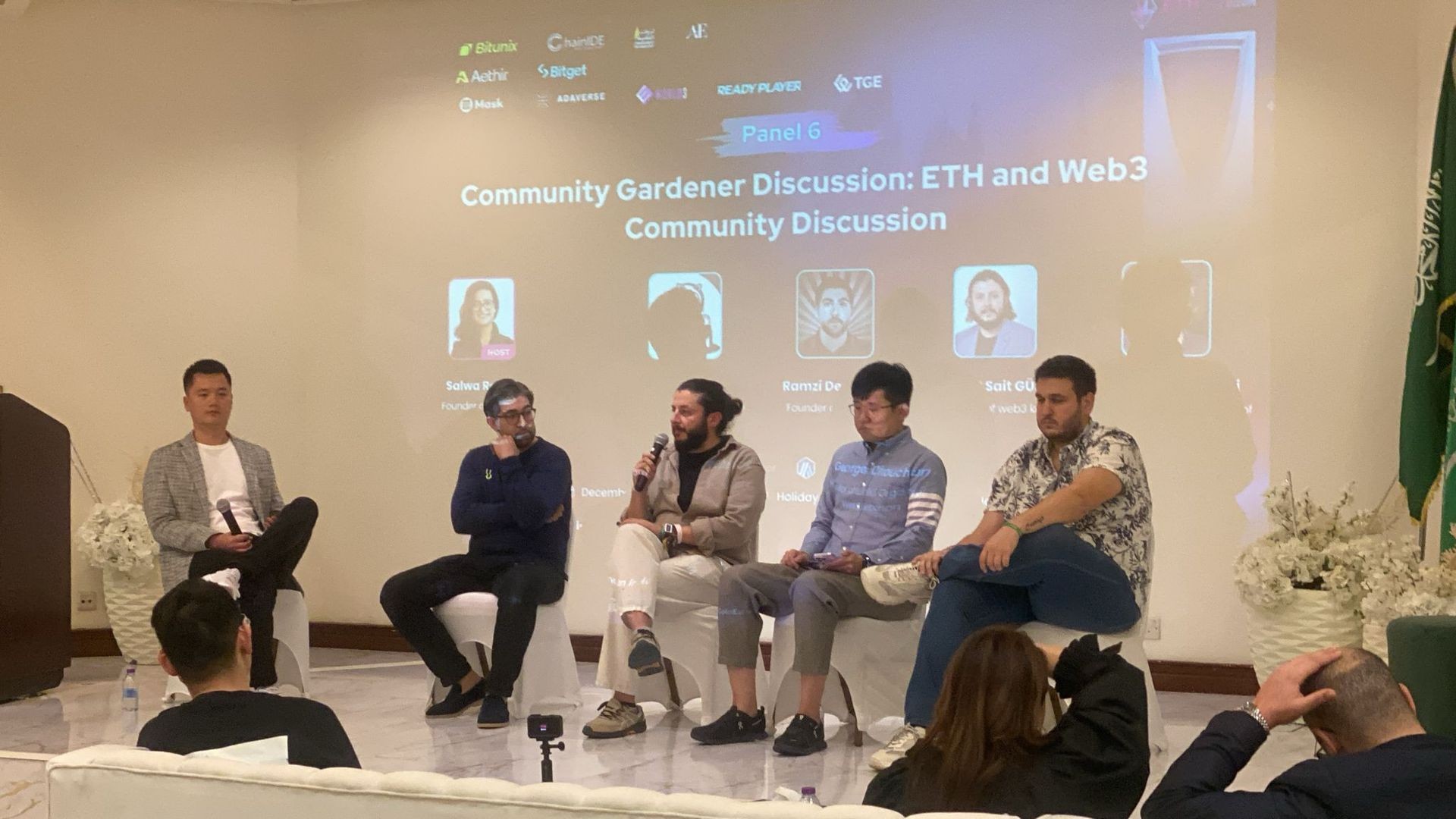 Panelists seated on stage discussing ETH and Web3 community topics with audience in attendance.